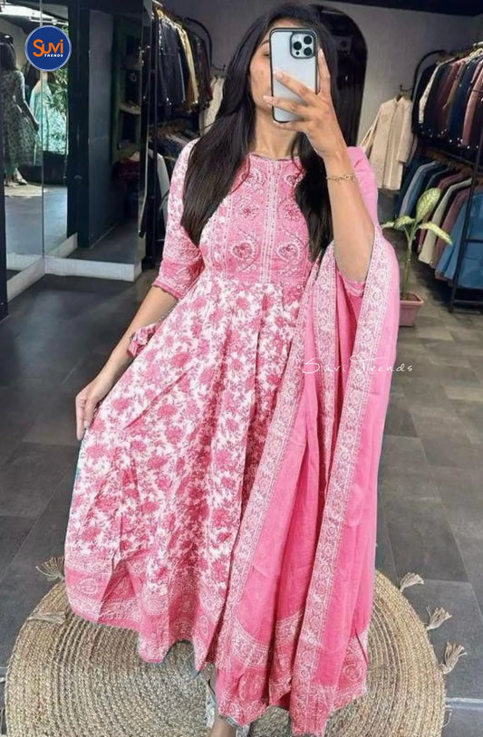 Elevate your style with our Cotton Printed Anarkali Suit in elegant pink. This set features a beautiful asymmetric neck and 3/4 sleeves. Made of soft cotton, it's comfortable and flares gracefully. Complete with a chic pant and dupatta adorned with tassels. Perfect for Indian ethnic wear enthusiasts in Malaysia. Get yours online now!
