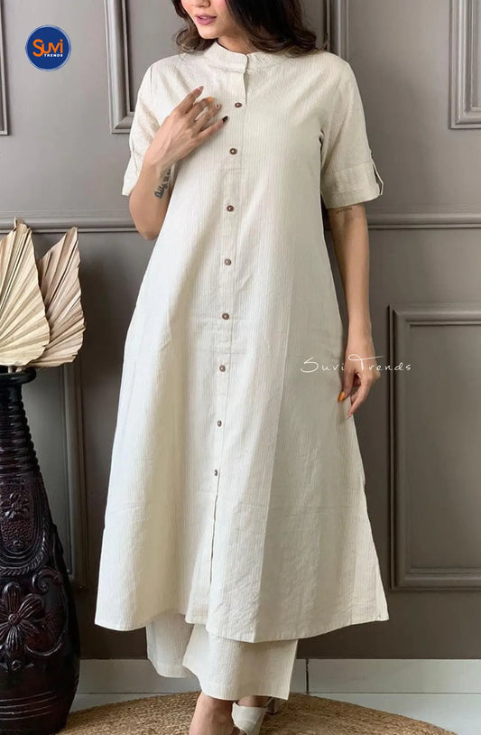 This handloom cotton suit set, designed with a Chinese collar and roll up sleeves, is perfect for the contemporary woman. The A-line cut and palazzo pants create a flattering silhouette, while the handloom cotton fabric offers comfort and style. Available for purchase online in Malaysia.